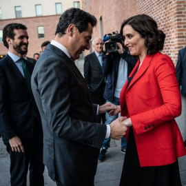 El presidente andaluz, Juanma Moreno Bonilla, saluda a la presidenta madrileña Isabel Díaz Ayuso, en presencia del líder nacional, Pablo Casado, en una imagen de archivo.
