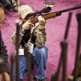Un niño coge un arma en EEUU. REUTERS/Archivo