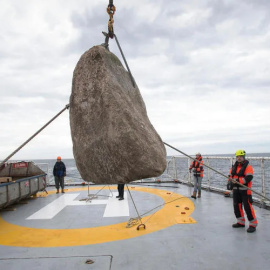 Operarios de Greenpeace se preparan para lanzar una roca gigante al mar. /Suzanne Plunkett / Greenpeace
