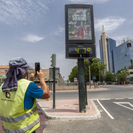 Un hombre fotografía un termómetro que marca 47 grados este miércoles en Murcia