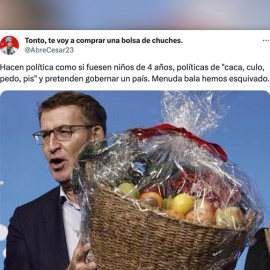 Feijóo repartiendo una cesta de frutas en la cena de Navidad del PP de Madrid.