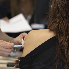 Una mujer recibe la tercera dosis de la vacuna contra el covid, en el Hospital Enfermera Isabel Zendal, a 13 de enero de 2022, en Madrid.