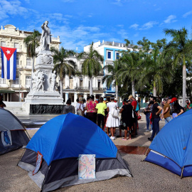 Jóvenes oficialistas instalan hoy carpas durante una sentada con pañuelos rojos en apoyo al Gobierno en el Parque Central de La Habana.