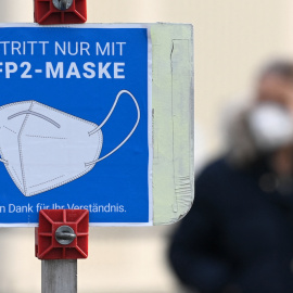 Un letrero informa a las personas que se cubran la boca y la nariz con una máscara FFP2 en el pequeño pueblo de Unterschleissheim, cerca de Múnich, en el sur de Alemania, el 18 de noviembre de 2021.