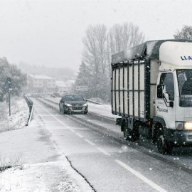 Varios vehículos circulan bajo la nieve en el municipio leonés de Riello este jueves. EFE