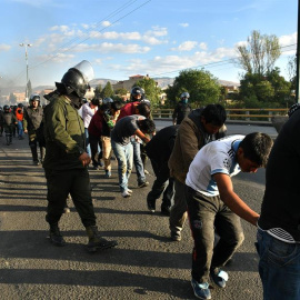 5/11/2019.- Policías bolivianos custodian a los detenidos luego de los choques con grupos de manifestantes este viernes, en Cochabamba (Bolivia).