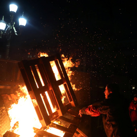 Un manifestante tira madera a un fuego originado por los activistas decepcionados por los resultados de la votación. / REUTERS - Marcos Brindicci