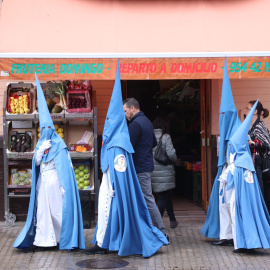 Varios nazarenos de la Hermandad de San Esteban llegando a su templo, en la Semana Santa de Sevilla 2022.