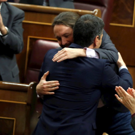 El líder de Unidas Podemos, Pablo Iglesias (i), abraza a Pedro Sánchez, tras su intervención ante el pleno del Congreso de los Diputados en la primera jornada de la sesión de investidura de Pedro Sánchez como presidente del Gobierno. EFE/Emilio Naran