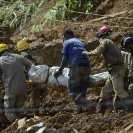 Un grupo de bomberos cargan un cuerpo rescatado tras un deslizamiento de tierras por fuertes lluvias en la ciudad de Jaboatão dos Guararapes, a 29 de mayo de 2022, en Brasil.