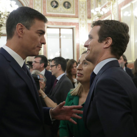 El presidente del Gobierno, Pedro Sánchez, conversa con el líder del PP, Pablo Casado, en presencia de la presidenta del Congreso, Ana Pastor, en el Salón de los Pasos Perdidos poco antes de la presentación de los actos conmemorativos del cuarenta ani