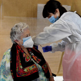Una empleada sanitaria inocula una dosis de la vacuna contra la covid-19.