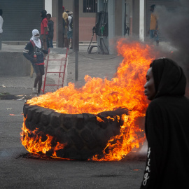 Personas encienden hoy neumáticos mientras protestan en Puerto Príncipe (Haití).