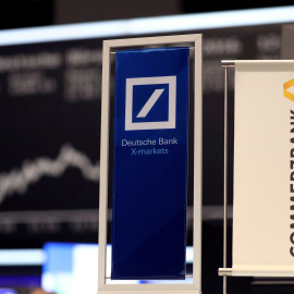 Banners of Deutsche Bank and Commerzbank are pictured in front of the German share price index, DAX board, at the stock exchange in Frankfurt, Germany, September 30, 2016. REUTERS/Kai Pfaffenbach/File Photo