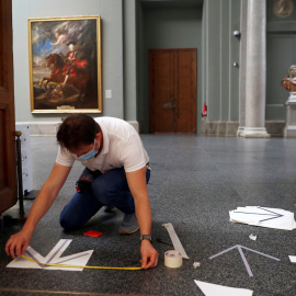  Un trabajador del Prado instala un señalizador en el suelo.- REUTERS/Susana Vera