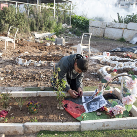 Un niño entierra a una persona cercana en Tulkram, Palestina.