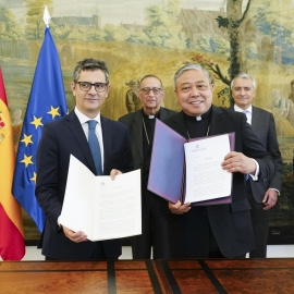 El ministro de la Presidencia, Félix Bolaños (i), intercambia documentos con el Nuncio en España, el arzobispo Bernardito Auza (d), durante un encuentro celebrado este miércoles en Madrid