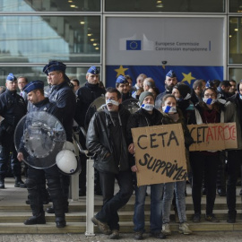 Policías belgas vigilan a los manifestantes concentrados frente al edificio de la Comisión Europea, durante la cumbre UE_canadá de octubre de 2016 en la que se firmó el CETA. AFP/jOHN tHYS