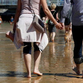 Numerosos donostiarras y visitantes disfrutan de una soleada jornada en la playa de La Concha de San Sebastián, donde este viernes los cielos se presentan poco nubosos o despejados salvo algún intervalo de nubes altas | EFE
