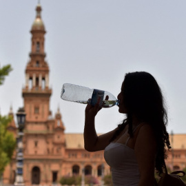 Una mujer bebe agua para combatir el calor abrasador durante una ola de calor, en Sevilla el 10 de julio de 2021.