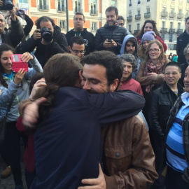 Alberto Garzón, líder de Izquierda Unida, y Pablo Iglesias, secretario general de Podemos, se abrazan en la Puerta del Sol de Madrid, para rubricar su acuerdo electoral. PODEMOS