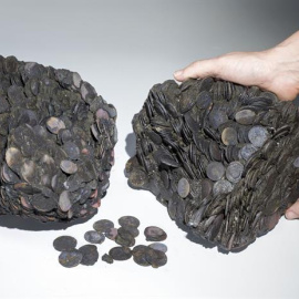 Fotografía de terrones de monedas que pesan 20 kilogramos, halladosen el interior de una vasija en un pecio junto al puerto antiguo de Cesárea .- AAI