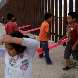 Los niños mexicanos se divierten en la frontera mientras juegan con niños norteamericanos, situados al otro lado de la valla. LUIS TORRES (AFP).