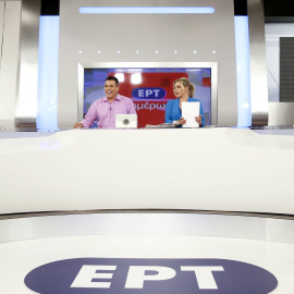 State television presenters Nikos Angelidis (L) and Vassiliki Haina prepare for the first broadcast of the station after its reopening./ REUTERS/Alkis Konstantinidis