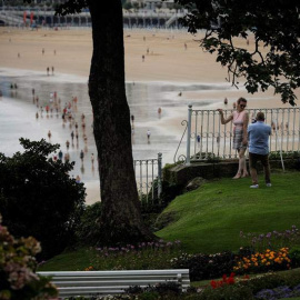 Una pareja se fotografía junto a la playa de La Concha de San Sebastián. (JAVIER ETXEZARRETA | EFE)