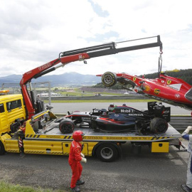 La grúa retira los coches de Alonso y Raikkonen. - EFE