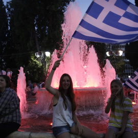 Turistas franceses portando banderas después de conocer el resultado del referéndum en Syntagma Square. EFE/YANNIS KOLESIDIS