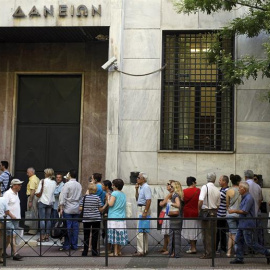 Un grupo de personas hace cola para realizar sus transacciones en el Fondo de Depósitos y Préstamos en Atenas. EFE/Orestis Panagiotou