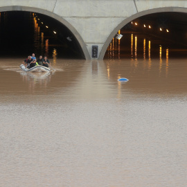 Los trabajadores de rescate en un bote rescatan a una persona que quedó atrapada dentro de un túnel inundado después de fuertes inundaciones en San Pedro del Pinatar. REUTERS / Sergio Perez