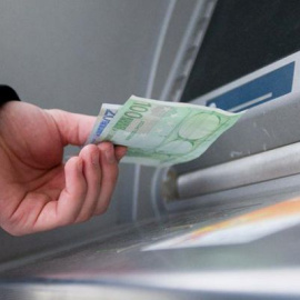 Un cliente retira dinero de un cajero automático.