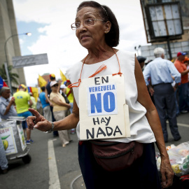 Una de las pocas personas que acudió a la manifestación que convocó la oposición venezolana este sábado en Caracas. REUTERS