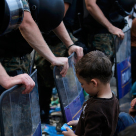 Una niña espera en la parte griega de la frontera con Macedonia el permiso para cruzar, cerca de la ciudad sureña de Gevgelija- EFE / EPA / GEORGI LICOVSKI.- REUTERS/Yannis Behrakis
