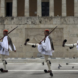 Greek Presidential guards take part in a ceremonial change of guards at the Monument of the Unknown Soldier in front of the Parliament building in Athens.- REUTERS.