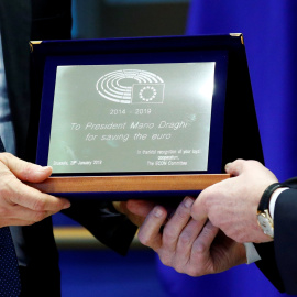 El presidente del Banco Central Europeo, Mario Draghi, recibe una placa de reconocimiento "por salvar el euro" de manos del presidente de la comisión de Asuntos Económicos de la Eurocámara, el socialdemócrata italiano Roberto Gualtieri, en 