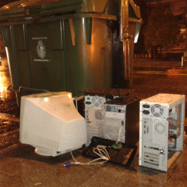 Ordenadores abandonados junto a un contenedor de basura en una calle de Vigo. Los componentes valiosos han desaparecido. /Patricia Pérez