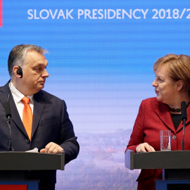 German Chancellor Angela Merkel speaks to Hungarian Prime Minister Viktor Orban during a news conference after the summit of the Prime Ministers of the Visegrad Group and Germany in Bratislava