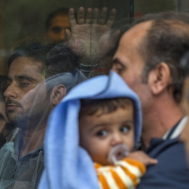 Varios refugiados esperan en la oficina extranjera para embarcarse en autobuses con dirección a los centros de refugiados en Bruselas, Bélgica. REUTERS / Yves Herman