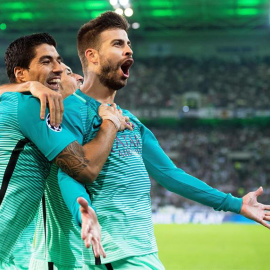 El jugador del Barcelona Gerard Pique celebra con su compañero Luis Suárez después de anotar el 2-1 durante un partido del grupo C de la Liga de Campeones de Europa UEFA, disputado entre el Barcelona y el Borussia Moenchengladbach en Moench