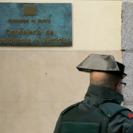 Un guardia civil en la entrada de la sede de la Consejería de la Presidencia de la Comunidad de Madrid. EFE/Juanjo Martín