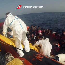 Fotograma cedida por la Guardia Costera italiana que muestra a la embarcación de varios refugiados a un barco durante una operación de rescate cerca de Lampedusa. EFE