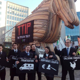 El caballo de Troya colocado frente a la sede de la Comisión Europea en Bruselas, en la protesta contra el Tratado de Libre Comercio, con algunos activistas de la organización Friends of the Earth.