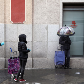  Varias personas guardan cola, manteniendo la distancia de seguridad, junto a un centro de Cáritas en Madrid. REUTERS/Sergio Perez