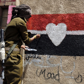 Un soldado pinta un grafiti para protestar contra el conflicto en Saná, Yemen. EFE/Yahya Arhab
