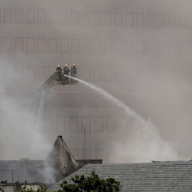 Bomberos trabajan en el incendio que afecta al Parlamento de Sudáfrica, en Ciudad del Cabo, este domingo 2 de enero de 2022.