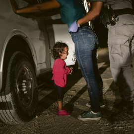 A two-year-old Honduran asylum seeker cries as her mother is searched and detained near the U.S.-Mexico border on June 12, 2018 in McAllen, Texas. They had rafted across the Rio Grande from Mexico and were detained by U.S. Border Patrol age