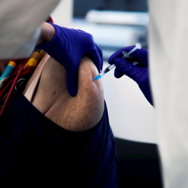 Una mujer se vacuna de la gripe y la covid-19 en Madrid.